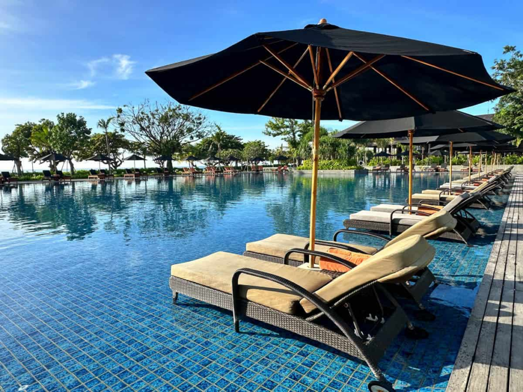 Beachfront resort with infinity pool and ocean views, representing relaxing stays at all-inclusive resorts in Sanur Bali.