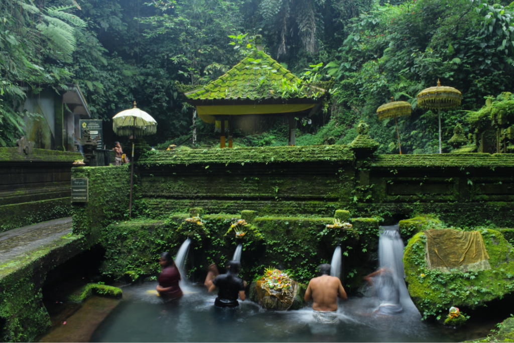 Devotees participating in a sacred water blessing ceremony at a temple, capturing the spiritual meaning of a Balinese purification ritual in Bali.