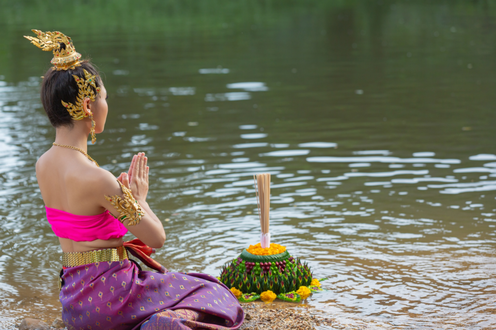 Spiritual guide leading participants through prayer and water cleansing during a Balinese purification ritual in Bali.