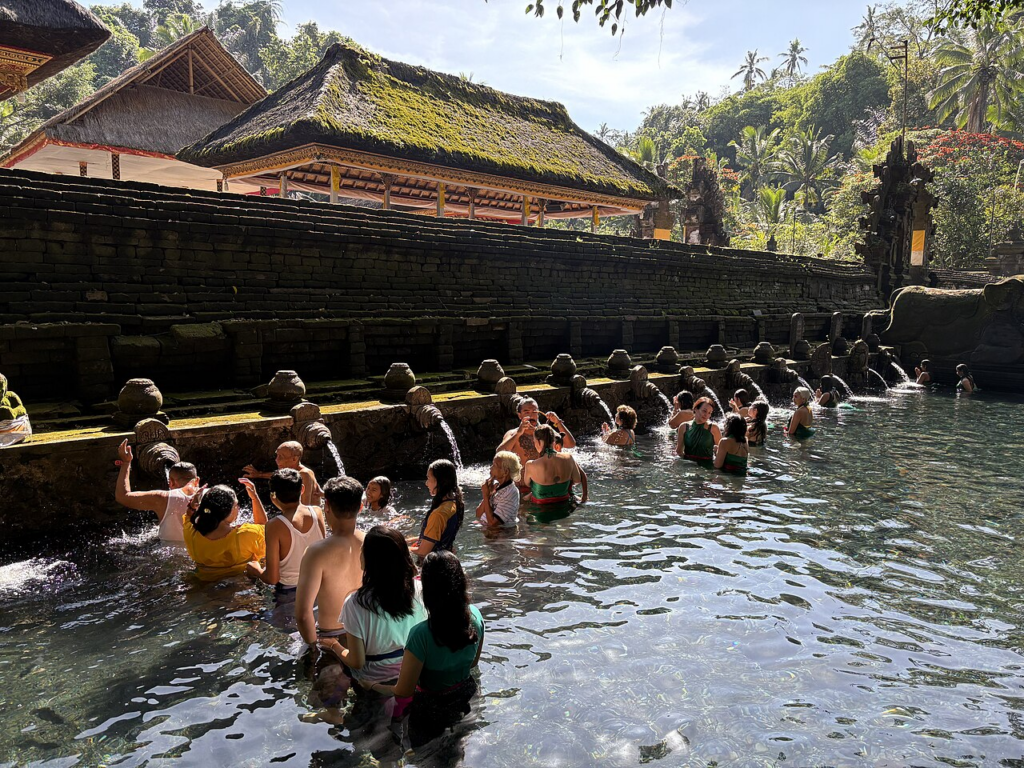 Offerings of flowers and incense prepared before a temple cleansing ceremony, symbolizing a Balinese purification ritual in Bali.