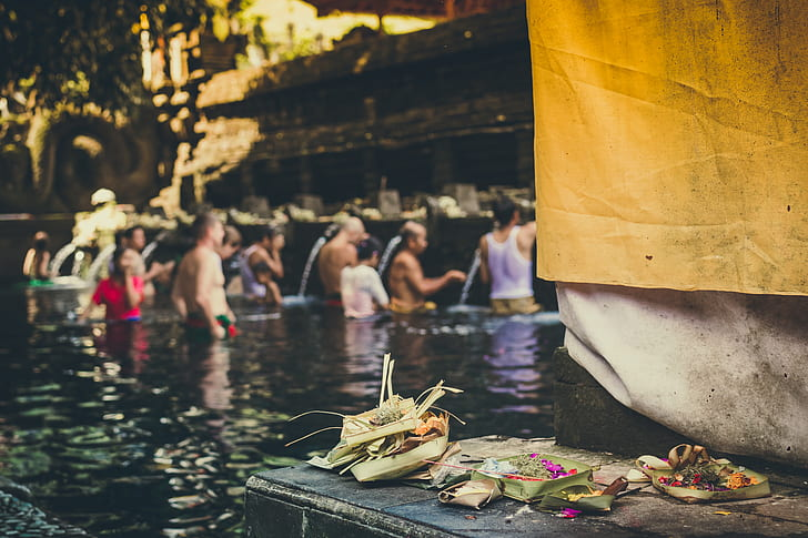 Devotees participating in a sacred water blessing ceremony at a temple, capturing the spiritual meaning of a Balinese purification ritual in Bali.