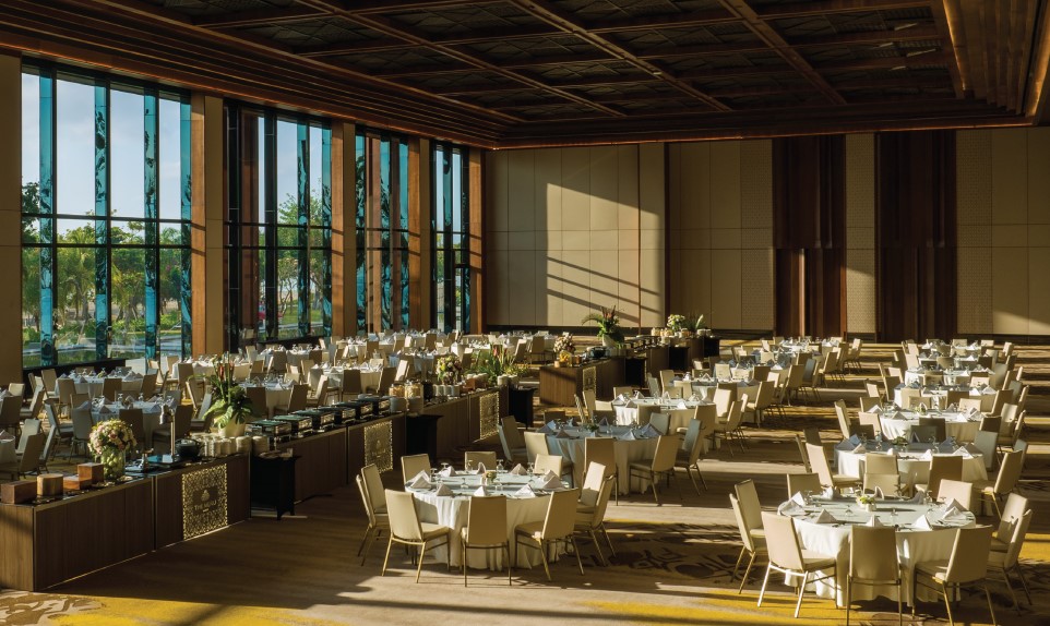 A Beachfront Wedding in Sanur Bali Defined by Elegance and Privacy 25 Wedding guests seated by the shore during a golden hour beachfront wedding Sanur Bali with panoramic sea views.