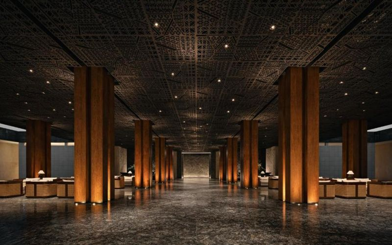 A Beachfront Wedding in Sanur Bali Defined by Elegance and Privacy 3 Wedding guests seated by the shore during a golden hour beachfront wedding Sanur Bali with panoramic sea views.