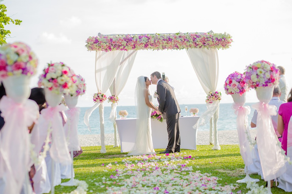 A Beachfront Wedding in Sanur Bali Defined by Elegance and Privacy 17 Professional wedding planner arranging aisle décor for a bespoke beachfront wedding Sanur Bali event.
