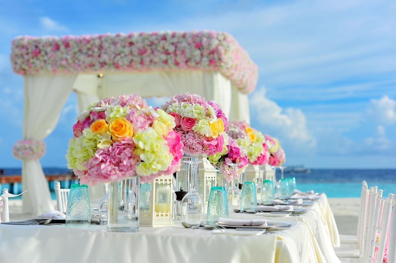 Elegant floral arch set against the ocean backdrop for a romantic beachfront wedding Sanur Bali at sunset.