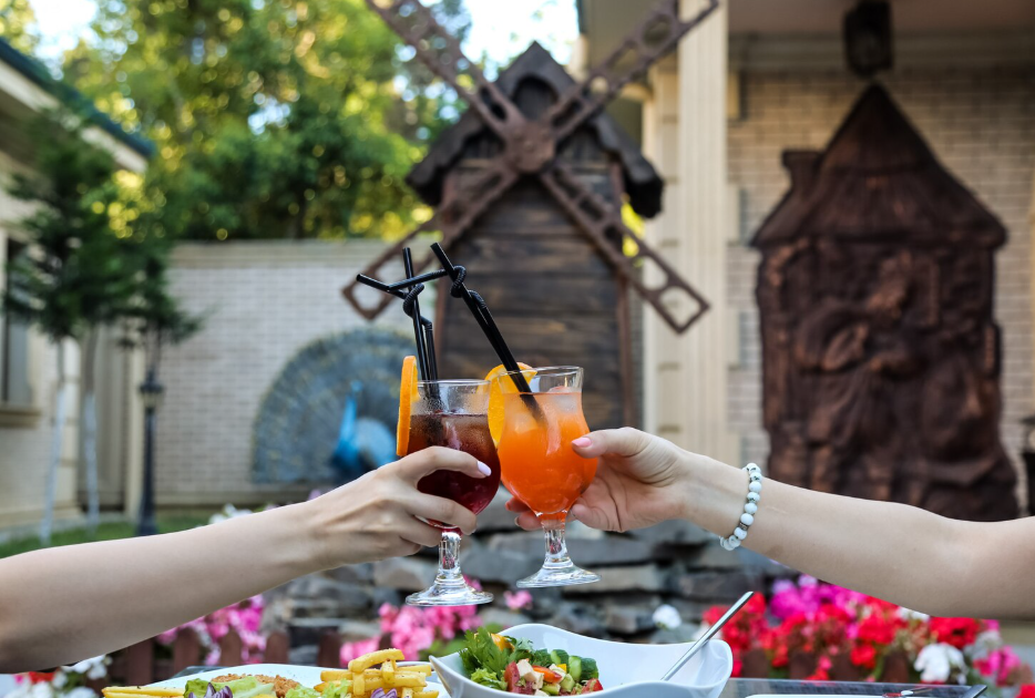 Guests enjoying traditional Balinese cuisine in a tropical garden setting, representing the best restaurants in Sanur Bali.