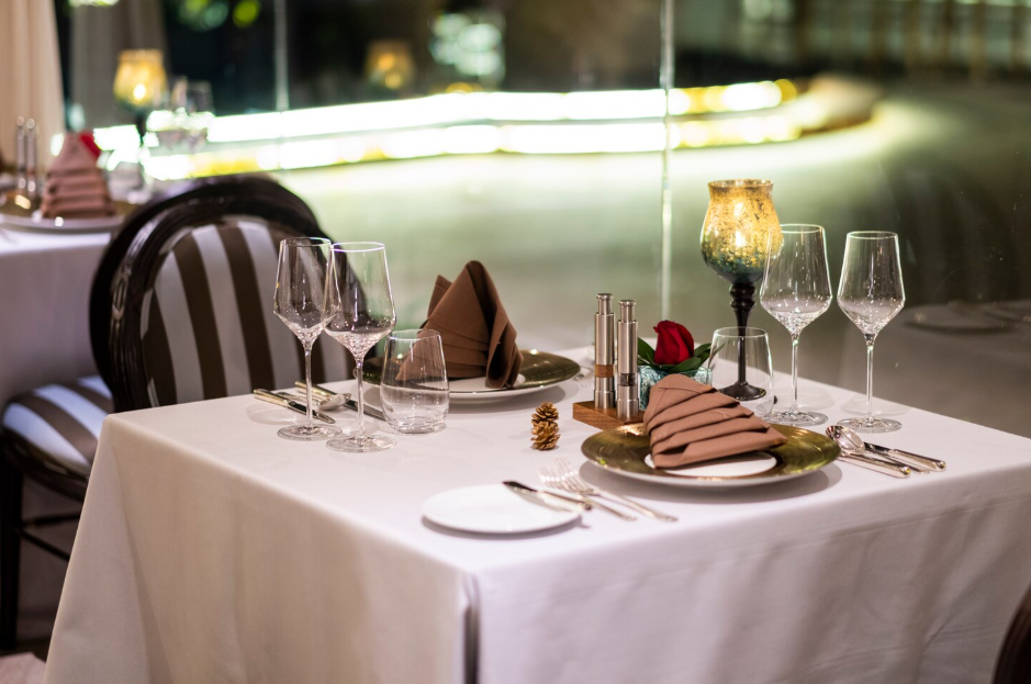 Best Restaurants in Sanur Bali: A Curated Guide to Local and Fine Dining 15 Romantic candlelit dinner by the shoreline, capturing the atmosphere of the best restaurants in Sanur Bali.