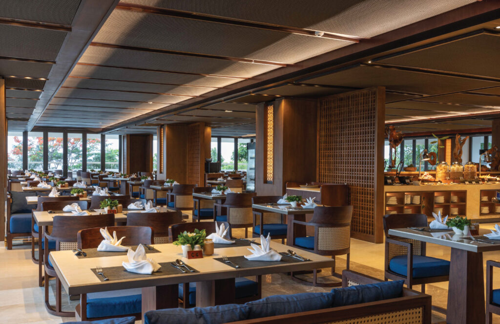 Luxury Restaurants in Sanur, Bali: Elegant Coastal Dining Experiences 17 Guests enjoying sunset cocktails on a seaside terrace, a signature experience at luxury restaurants in Sanur Bali.