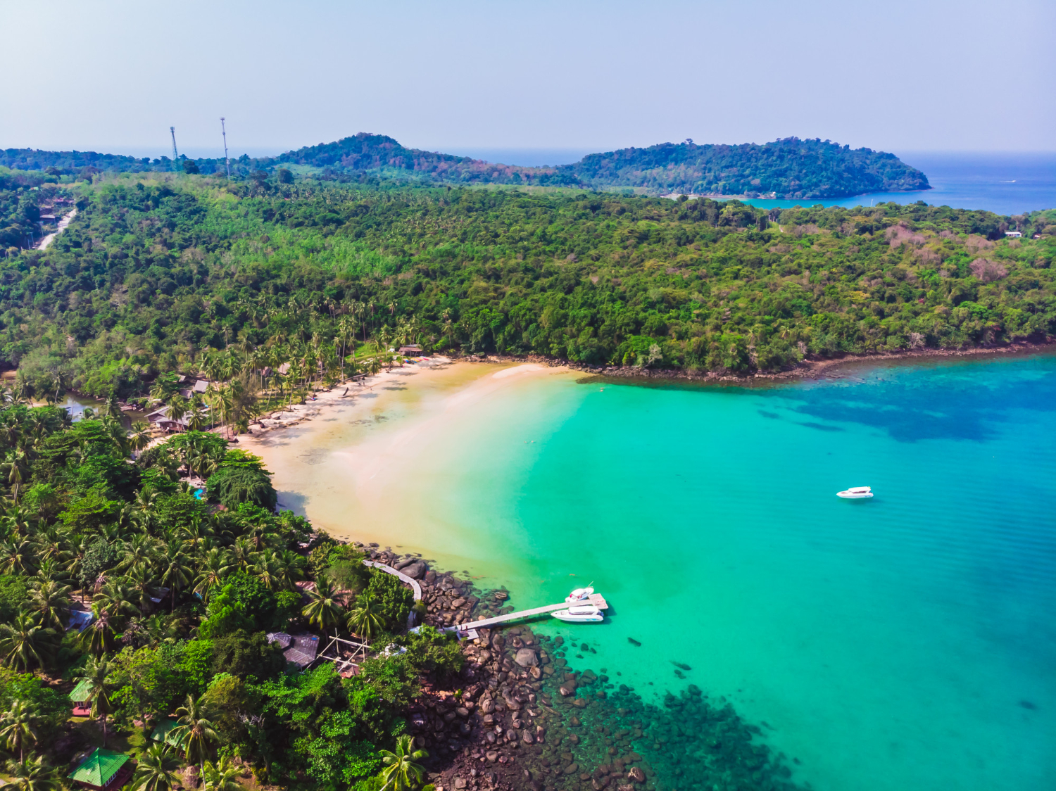 Aerial view of the long coastline and clear waters surrounding Sanur Beach Bali.