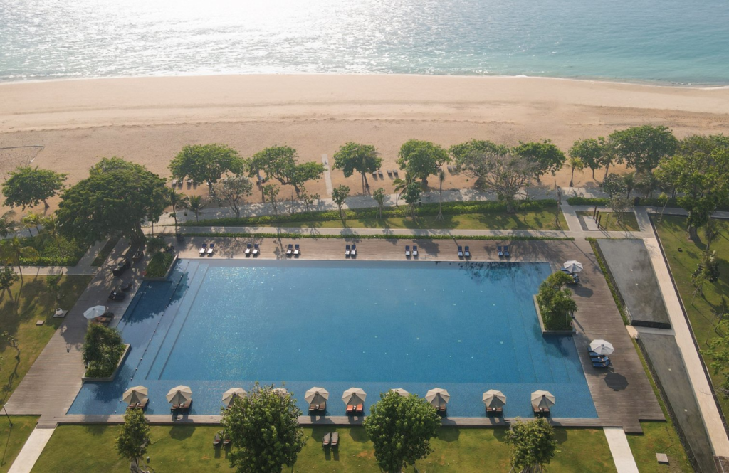 A Beachfront Wedding Experience Defined by Privacy and Elegance 17 Modern beachfront resort with palm-lined gardens, ideal setting for a memorable wedding resort Sanur celebration.