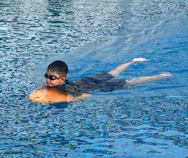 Beachfront view at one of the best family resorts in Sanur Bali with kids enjoying the pool