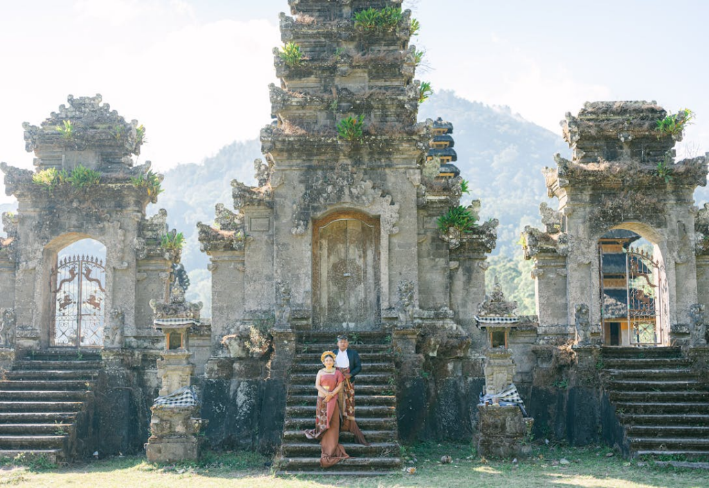 Visitors exploring Besakih Temple in Bali, walking through the sacred temple complex surrounded by lush greenery.