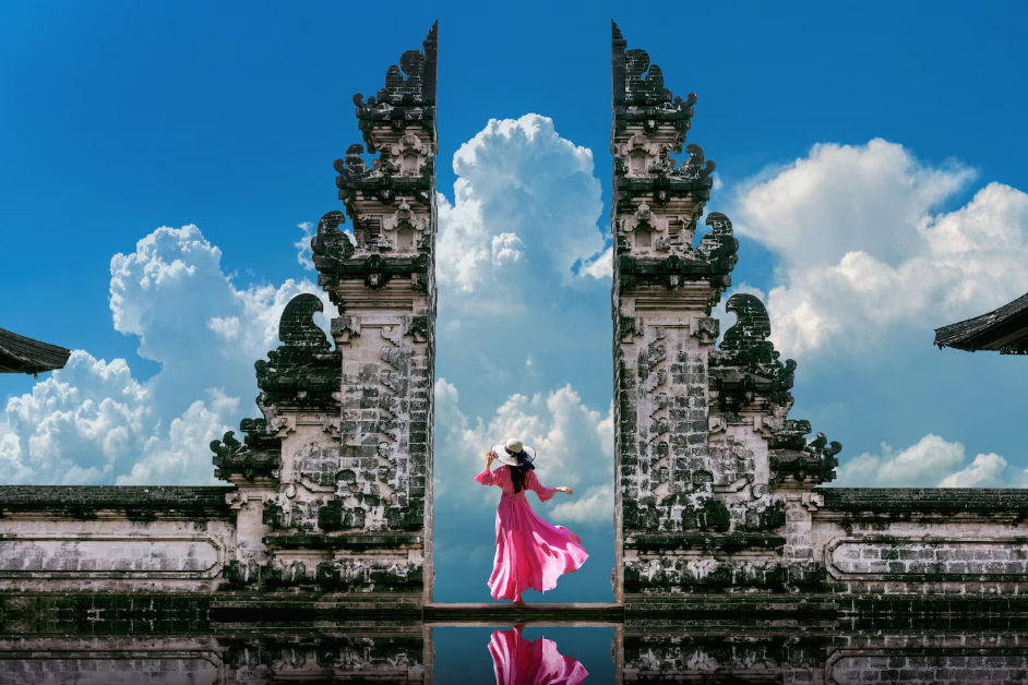 Visitors exploring Besakih Temple in Bali, walking through the sacred temple complex surrounded by lush greenery.