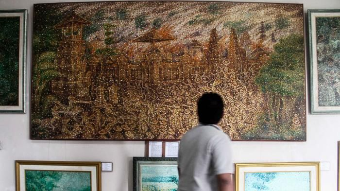 Inside Bali's Fingerprint Painting Museum (2026 Review) 11 Visitors viewing exhibits at the Fingerprint Painting Museum, featuring intricate fingerprint-based portraits and artistic creations.