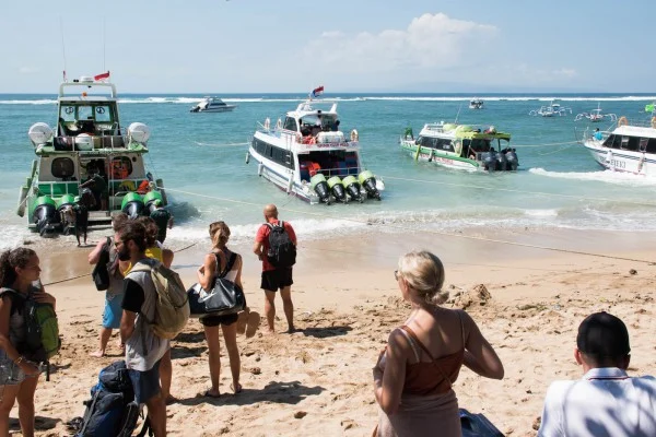 Travelers boarding a ferry from Sanur to Nusa Penida for a day trip adventure.
